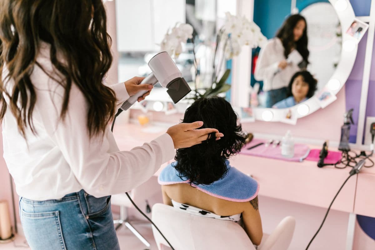 Hairstylist finishing a client's blowout